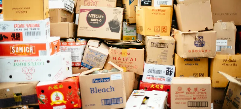 A cluttered assortment of various stacked cardboard boxes